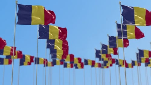 Many Romanian Flags Waving Against a Clear Blue Sky