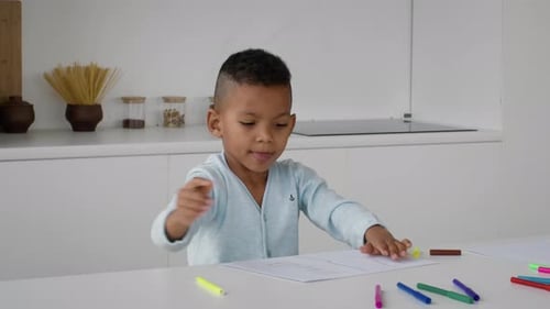 Young Boy Drawing at Table Indoors