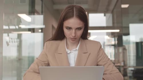 Young Woman Working at Computer in Modern Office