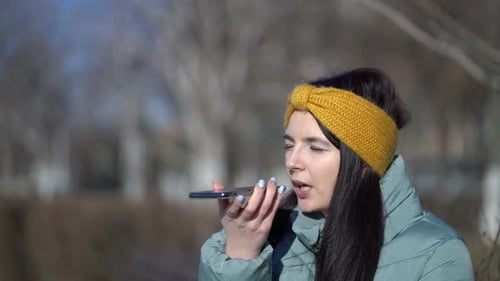 Young Woman Using Voice Assistant on Smartphone