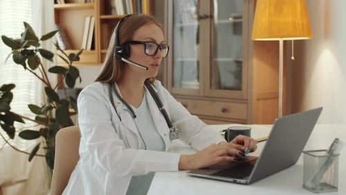 Female Doctor Giving Online Consultation on Web Call in Home Office