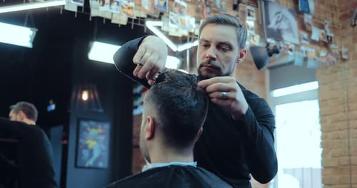 Barber Giving Haircut in Urban Barbershop