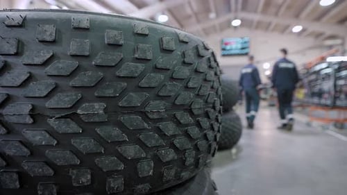 In the Foreground are Huge Wheels From Allterrain Vehicles or Trucks