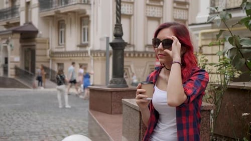 Woman With Red Hair Holds Coffee In City