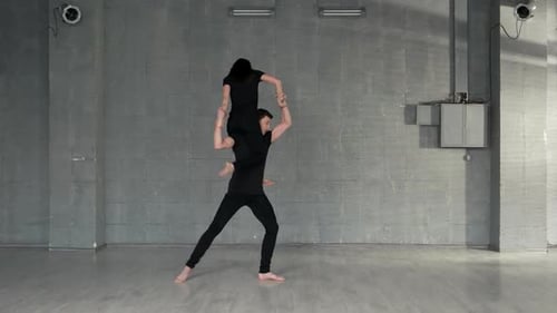 Acrobatic Couple Doing Dance Routine in Studio