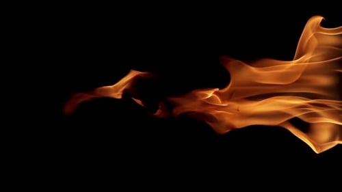 Golden Fire Flames Flickering Against Black Background