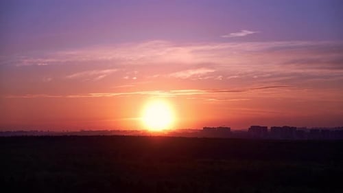 Golden Sunset Over City and Forest Landscape