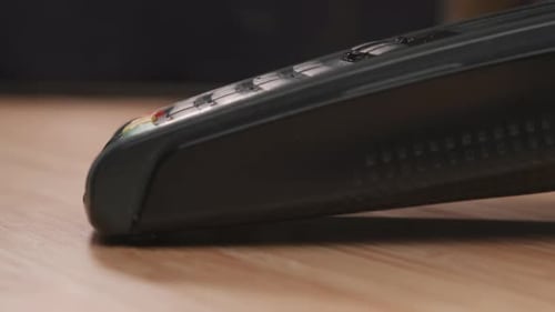 Finger presses buttons on a payment terminal