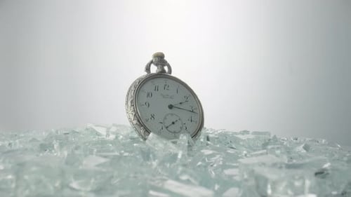 Elegant Pocket Watch Resting on Shattered Material