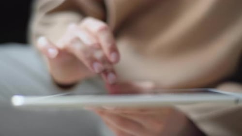 Top View Close Up Of A Young Indian Woman Using A Tablet Tapping And Touching The Screen