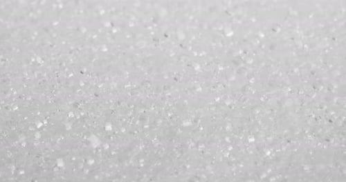 Stack of white sugar in rotation