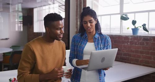 Young Professionals Discussing Project in Modern Office