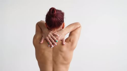 Woman Massages Back and Shoulders for Flexibility