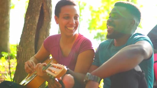 Latin Hispanic Couple in Love Together in Great Sunny Day in Park with Guitar and Tent