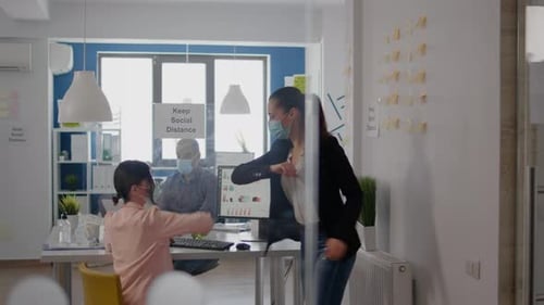 Coworkers Touching Elbow to Avoid Infection with Coronavirus