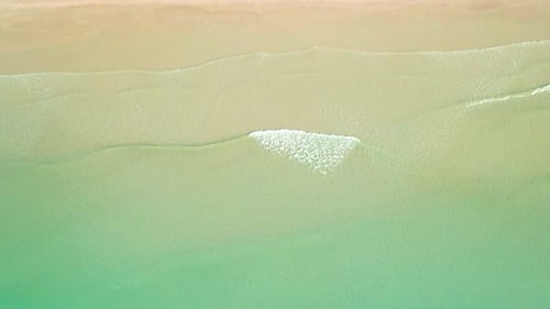 4K Aerial view top view of drone, sea waves and beautiful sand beach.