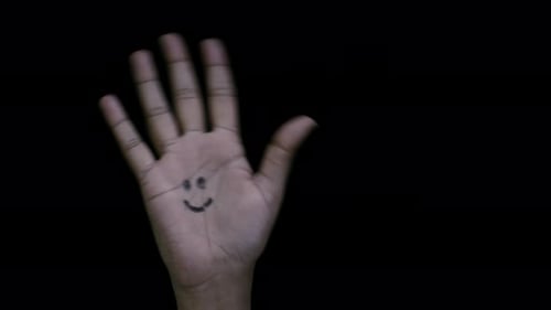 Hand Opens, Revealing Smiley Face on Palm