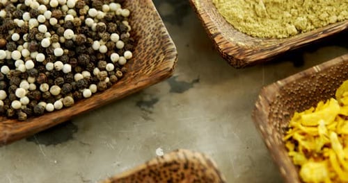 Colorful Spices Displayed in Wooden Bowls