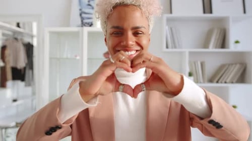 Smiling Woman Making Heart Shape With Hands