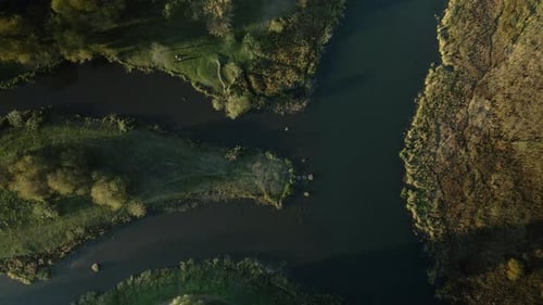 Park area. A winding river. Trees with yellow autumn leaves are visible. Aerial photography.