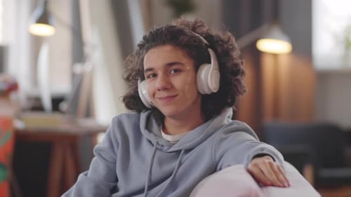 Teen with Headphones Smiling Indoors