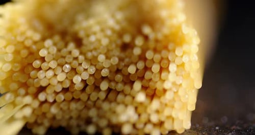 Close Up of Uncooked Spaghetti on Dark Surface