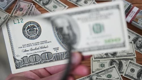 Examining Money with Magnifying Glass, Close Up