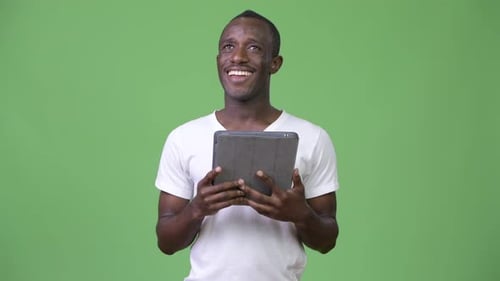 Man Holding Tablet on Green Screen Background