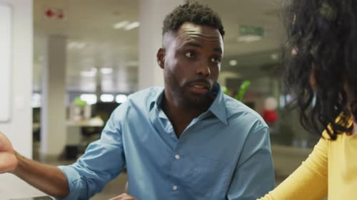 Colleagues Discussing Project in Modern Office