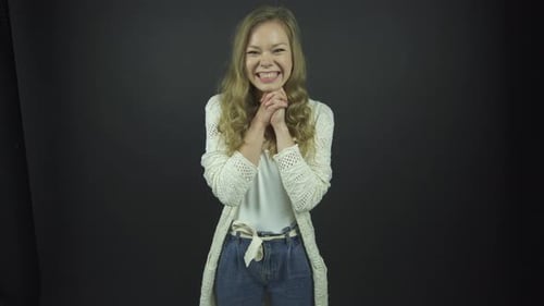Smiling Young Woman in Front of Black Background