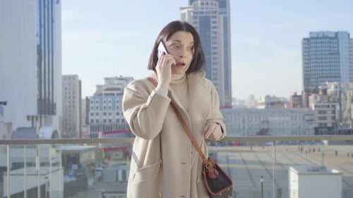 Middle Shot of Successful Caucasian Woman Talking on the Phone. Young Brunette Lady Standing on City