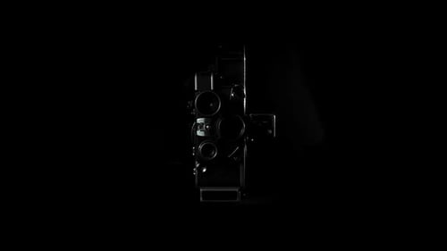 Vintage Film Camera Rotating on Black Background