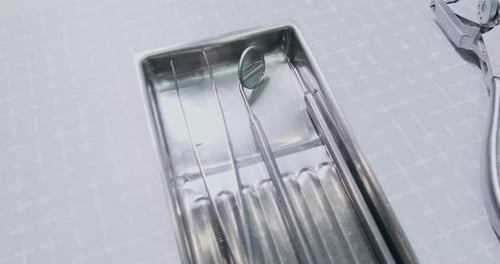 Dental tools sitting in stainless steel tray