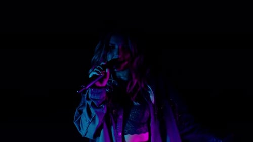 Live Vocal Performance of Singer in Darkness Vocalist Cute Girl in Neon Light Dancing Singing