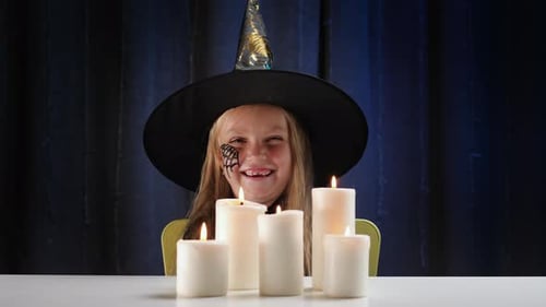 Smiling Girl With Witch Hat and Candles