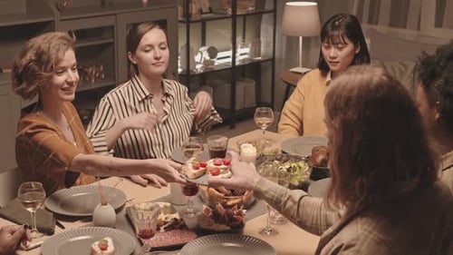 Friends Share Food and Wine at Dinner Party