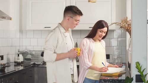 Young Couple Plans in Bright, Modern Kitchen