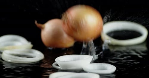 Fresh Onions Sliced on Black Background