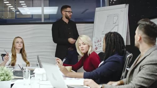 Diverse Team Attends Business Meeting at Night