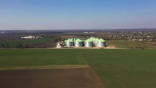 Aerial View of the Steel Grain Silos Outdoors Near the Fields