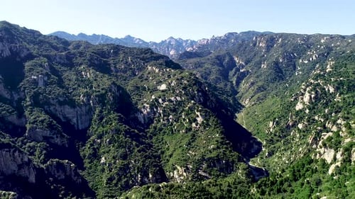 Aerial View of Green Mountain Mountain Peak with Beautiful Blue Sky.