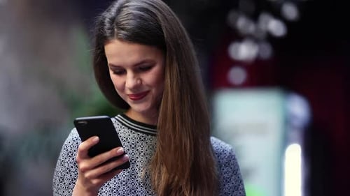 Woman With Mobile Phone Drinking Coffee In Cafe Portrait