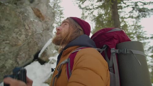 Man Taking Photos in Snowy Winter Wilderness