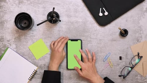 Smartphone with green screen chroma key, scrolling news, tapping on photos.