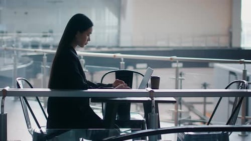 Japanese Business Lady Using Laptop Sitting In Coworking Center SideView