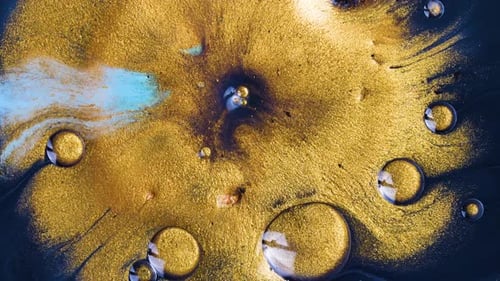 Abstract Swirling Gold Paint on Dark Background