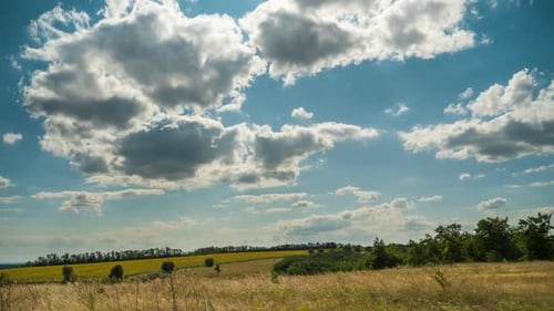 Landscape Dramatic Fields and Moving Storm Clouds in Blue Sky. Timelapse. Amazing Rural Valley