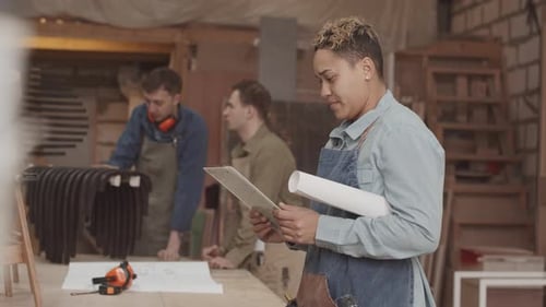 Portrait of Female Woodworker in Carpentry Workshop