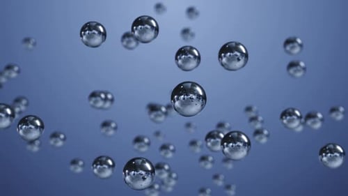 Multiple Reflective Spheres Floating on Blue Backdrop