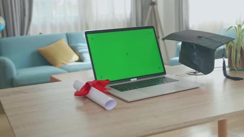 Graduation Cap And Diploma With Mock Up Green Screen Laptop Computer